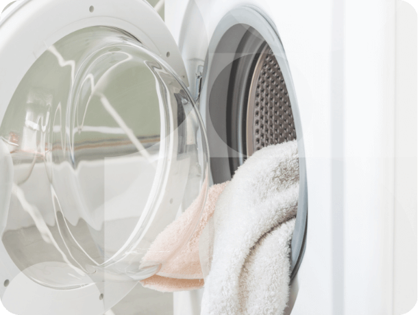 Dry clothes hanging out of a washer dryer.
