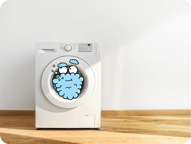 Freestanding washing machine, filled with laundry.
