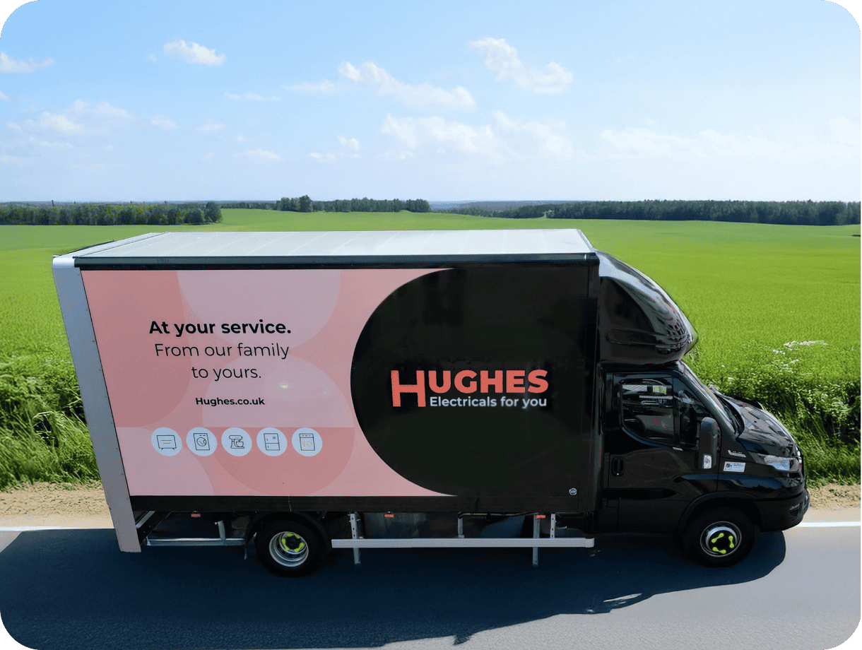 A Hughes delivery van driving on the road.