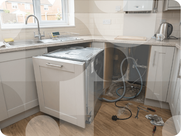 Kitchen with dishwasher pulled out showing plumbing and electrical connections during installation or removal.