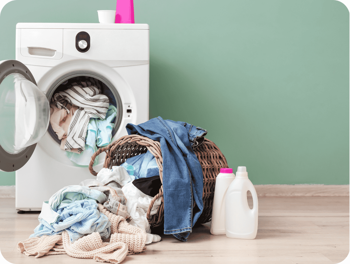 A washing machine with a pile of laundry. 