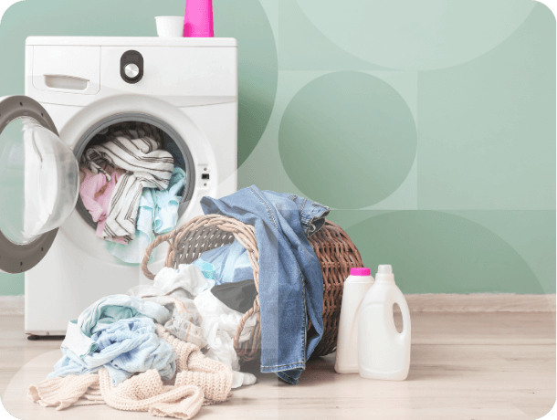 A washing machine with a pile of laundry. 